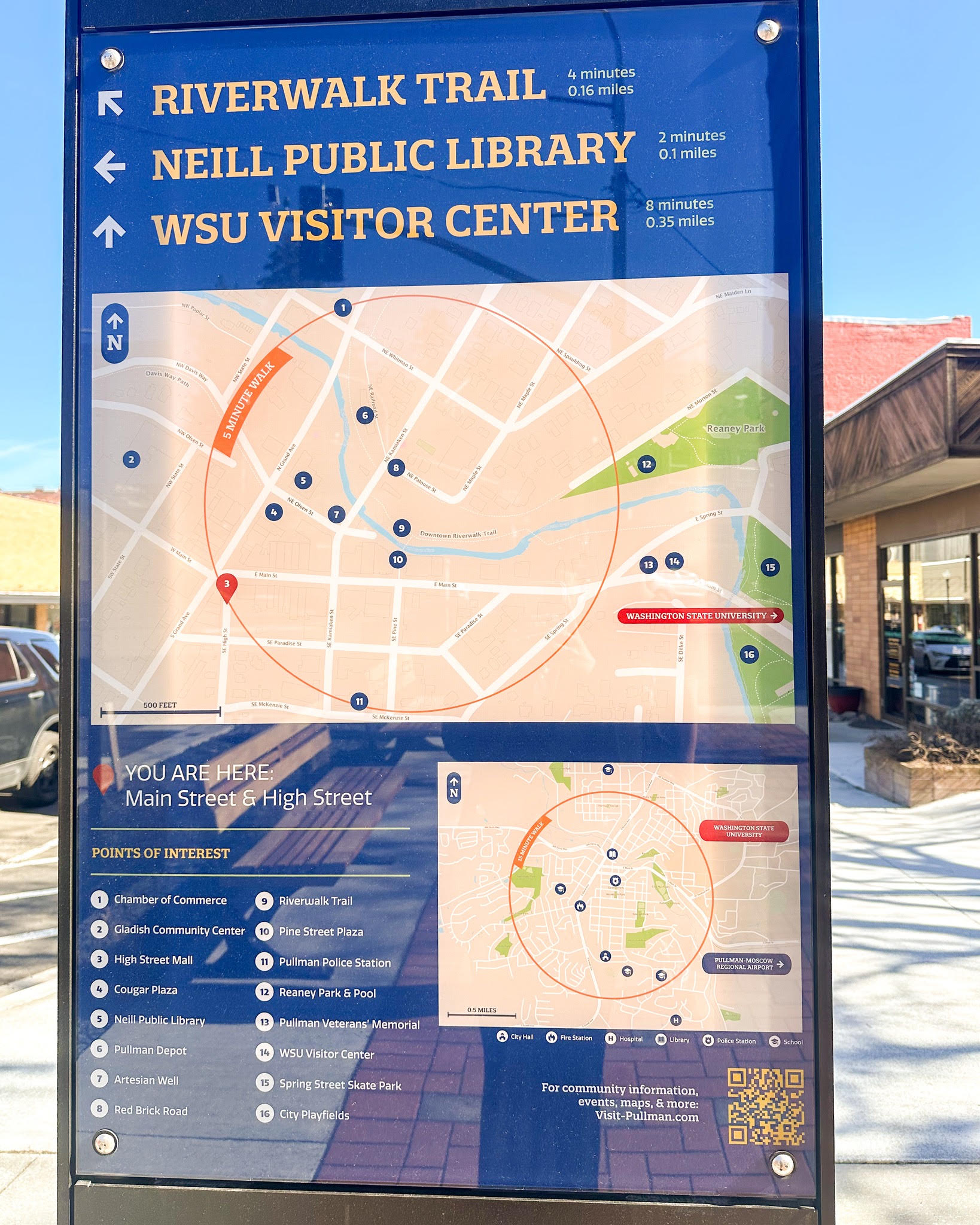 Outdoor community wayfinding directory with destination arrows and a detailed pedestrian map