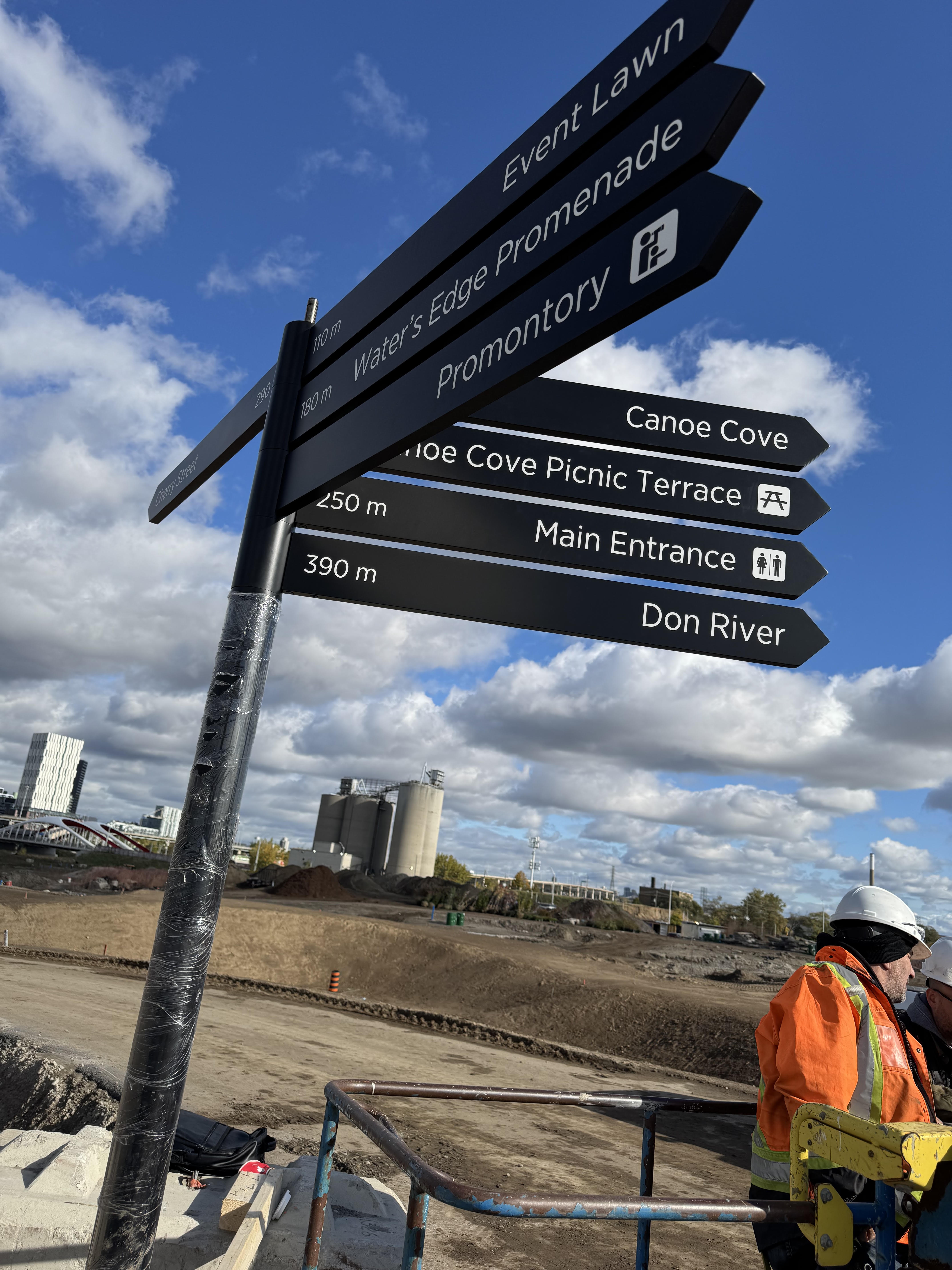 Directional wayfinding signs in a public construction environment